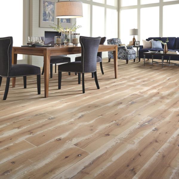 textured wood flooring in open concept dining room and living room